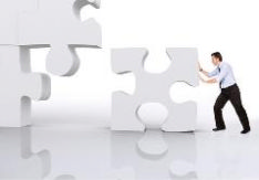 The image shows a man pushing the missing jigsaw piece into the last space in the jigsaw, reflecting the idea of the recruiter finding the perfect candidate for the job they have been advertising.
